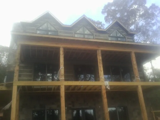 Dormers and porch framing on a large log home under construction in Boulevard